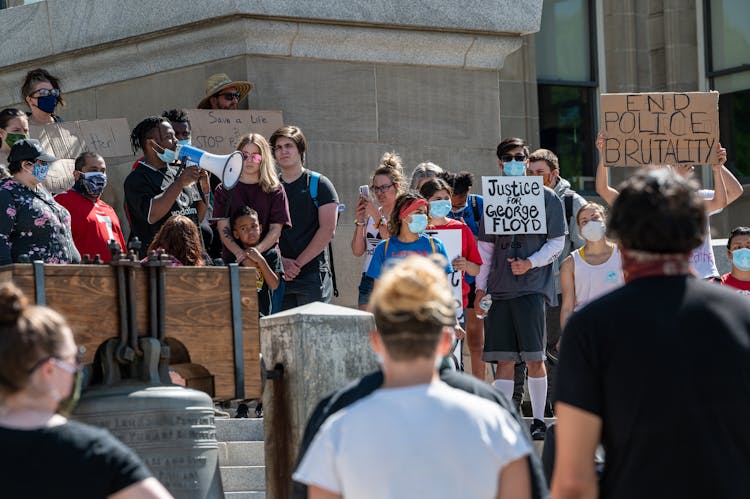 Group Of Protesting People Standing On Street