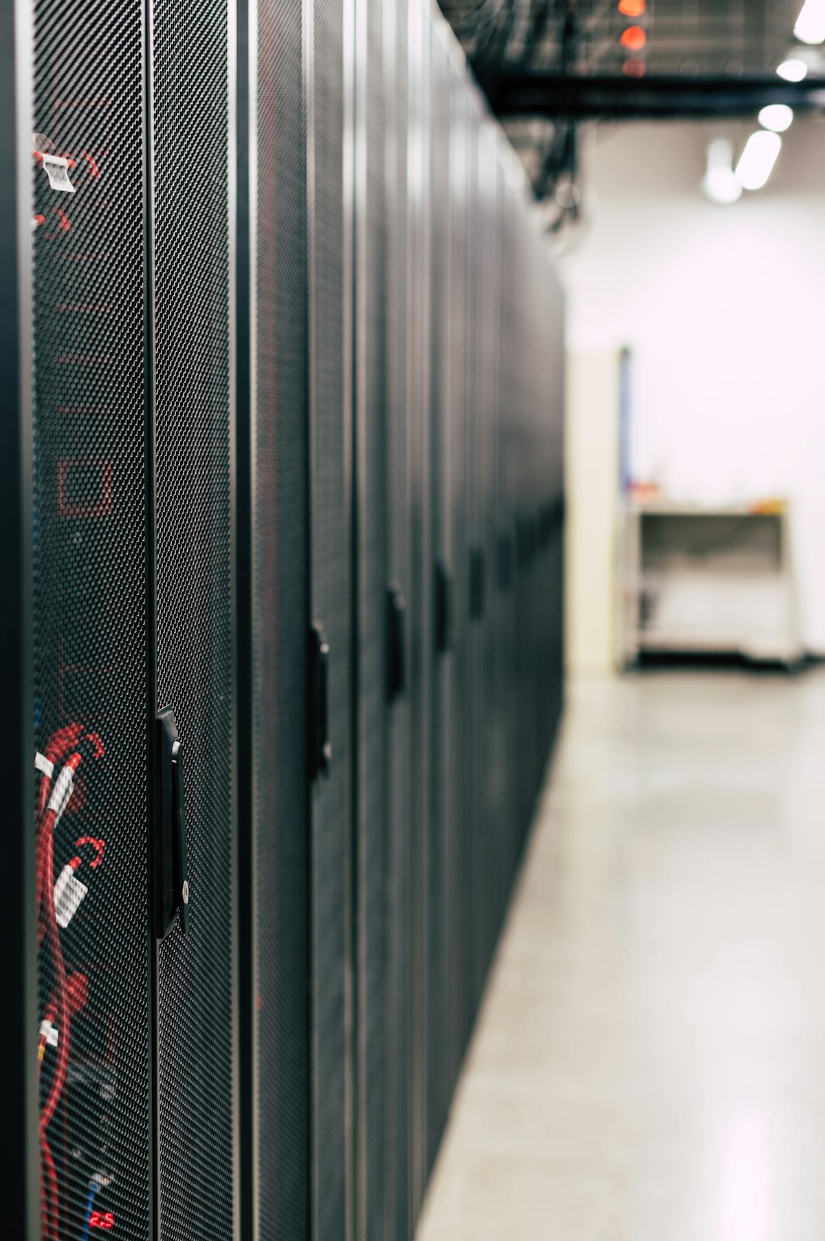 Rows of server racks inside a data center.