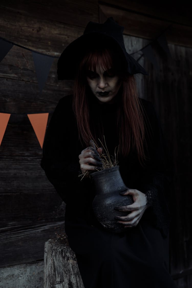 Witch Holding A Clay Jar