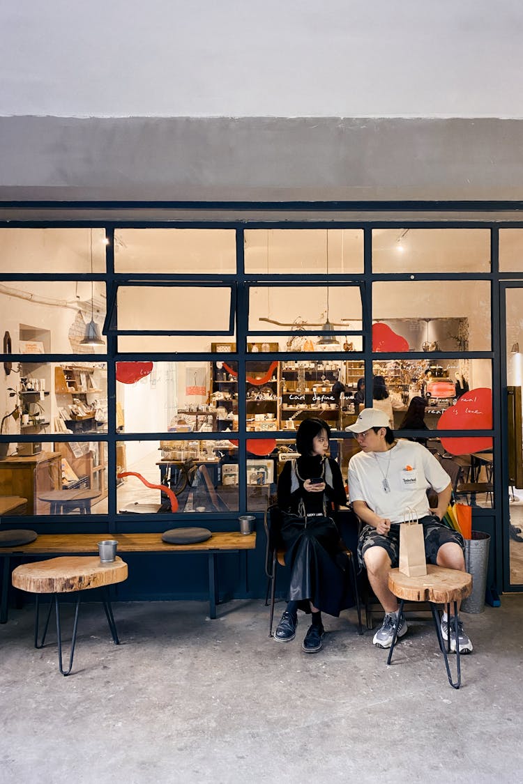 Couple Sitting  Outside Shop