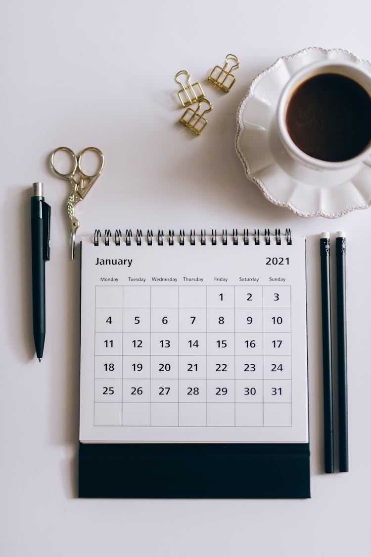 Desk Calendar Beside Black Click Pen 