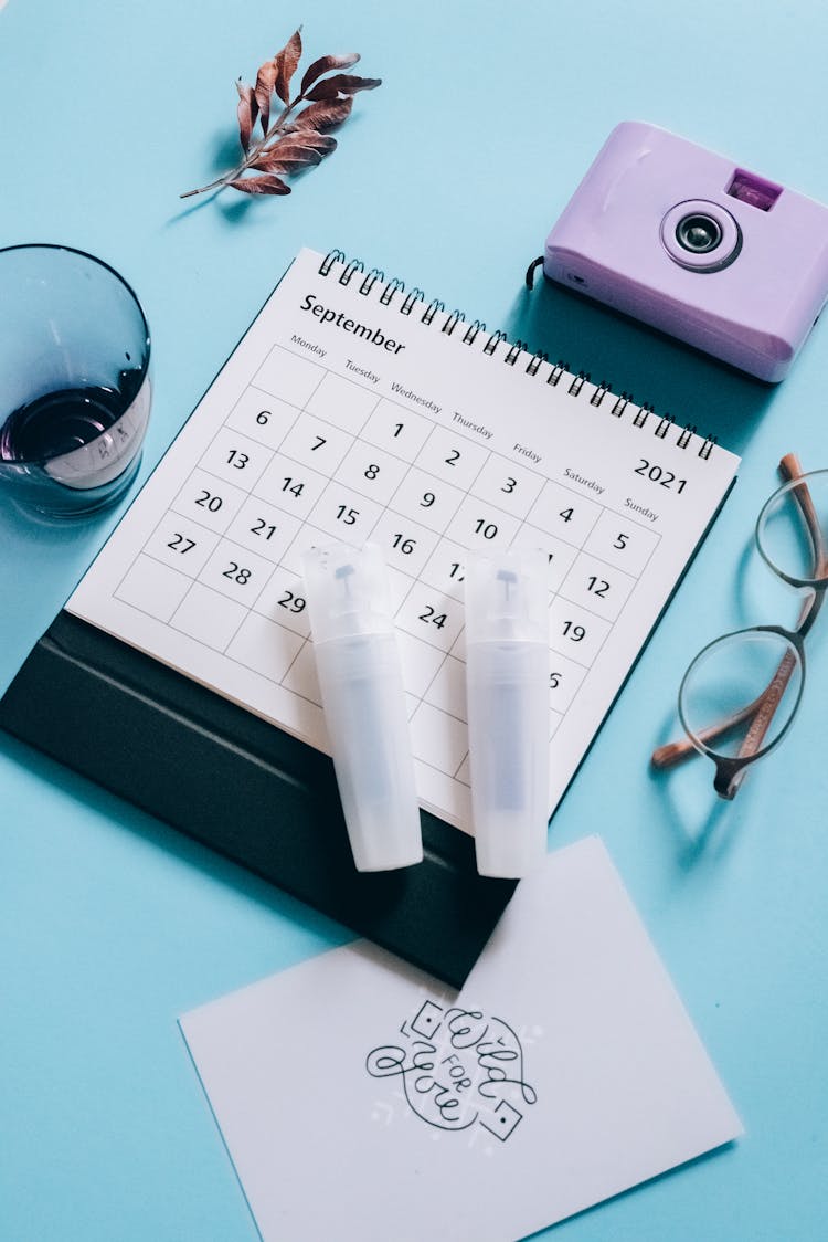 White Tube Containers On Desk Calendar