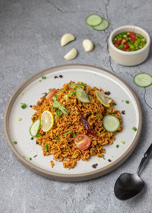 Spicy Noodles with Slices of Citrus on Round Plate