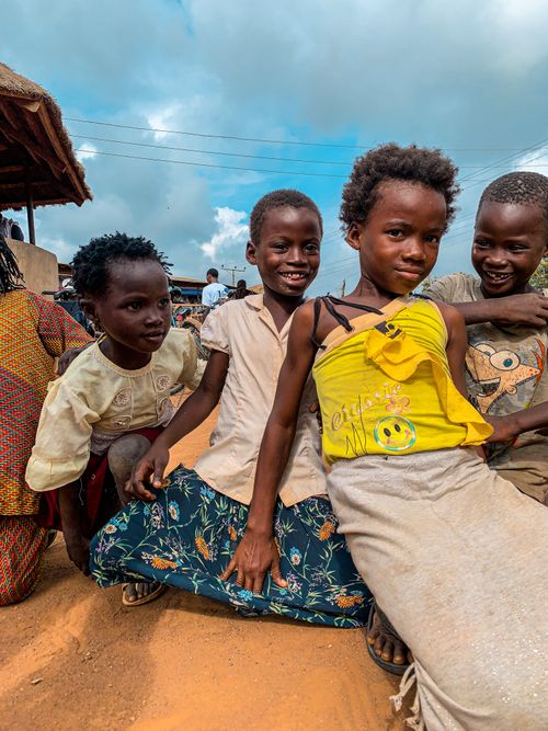 Free A group of smiling African children having fun outdoors, enjoying a bright day. Stock Photo
