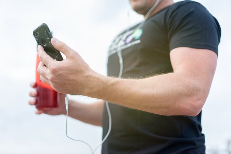 Man In Black Shirt Holding Black Smart Phone