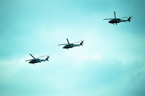 Helicopters in Mid Air Under Blue Sky