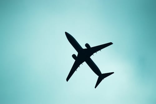 Silhouette of a Plane on a White Sky