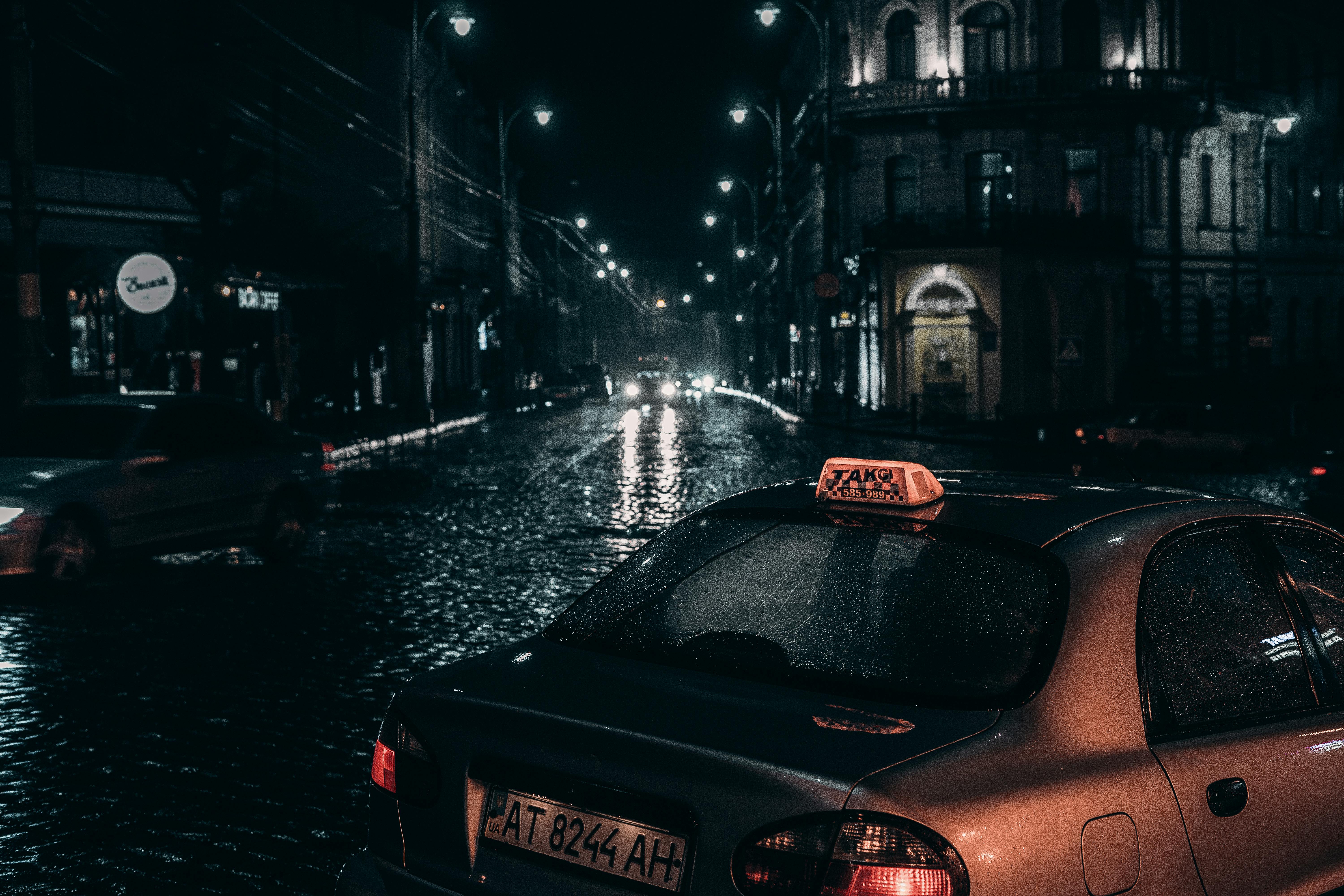 taxi placed on street in rainy evening