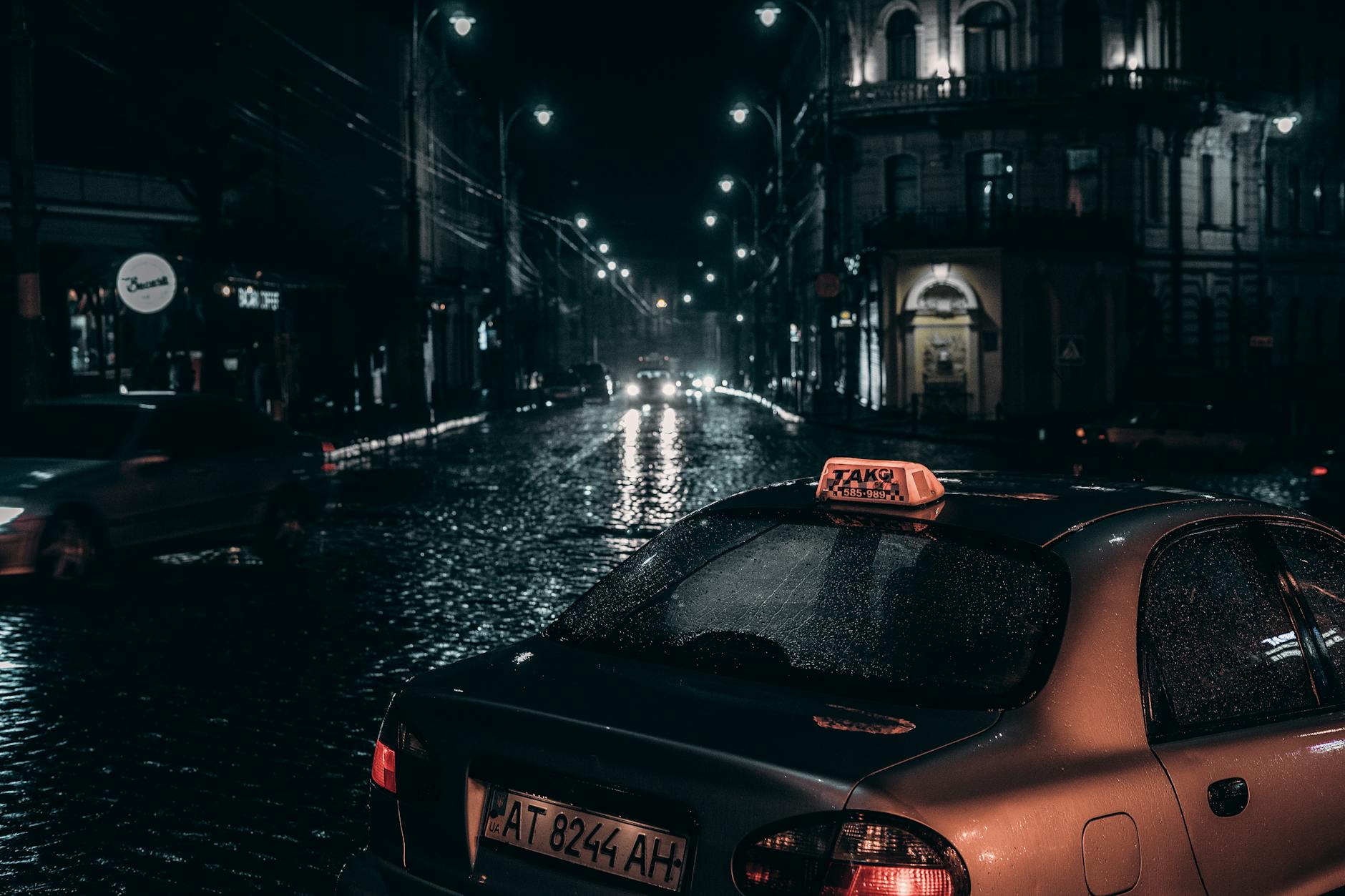 Taxi placed on street in rainy evening