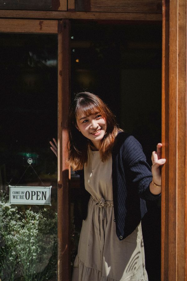 Shop owner arranging plants — Amina Filkins on Pexels