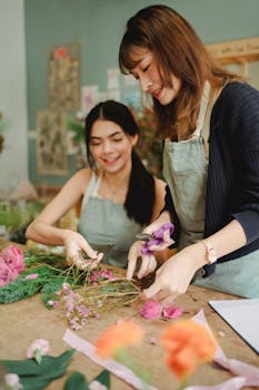 Two female florists collaborating to create a stunning bouquet in a flower shop.