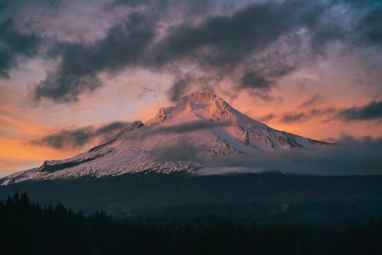 Snow Capped Mountain Under Gray Clouds