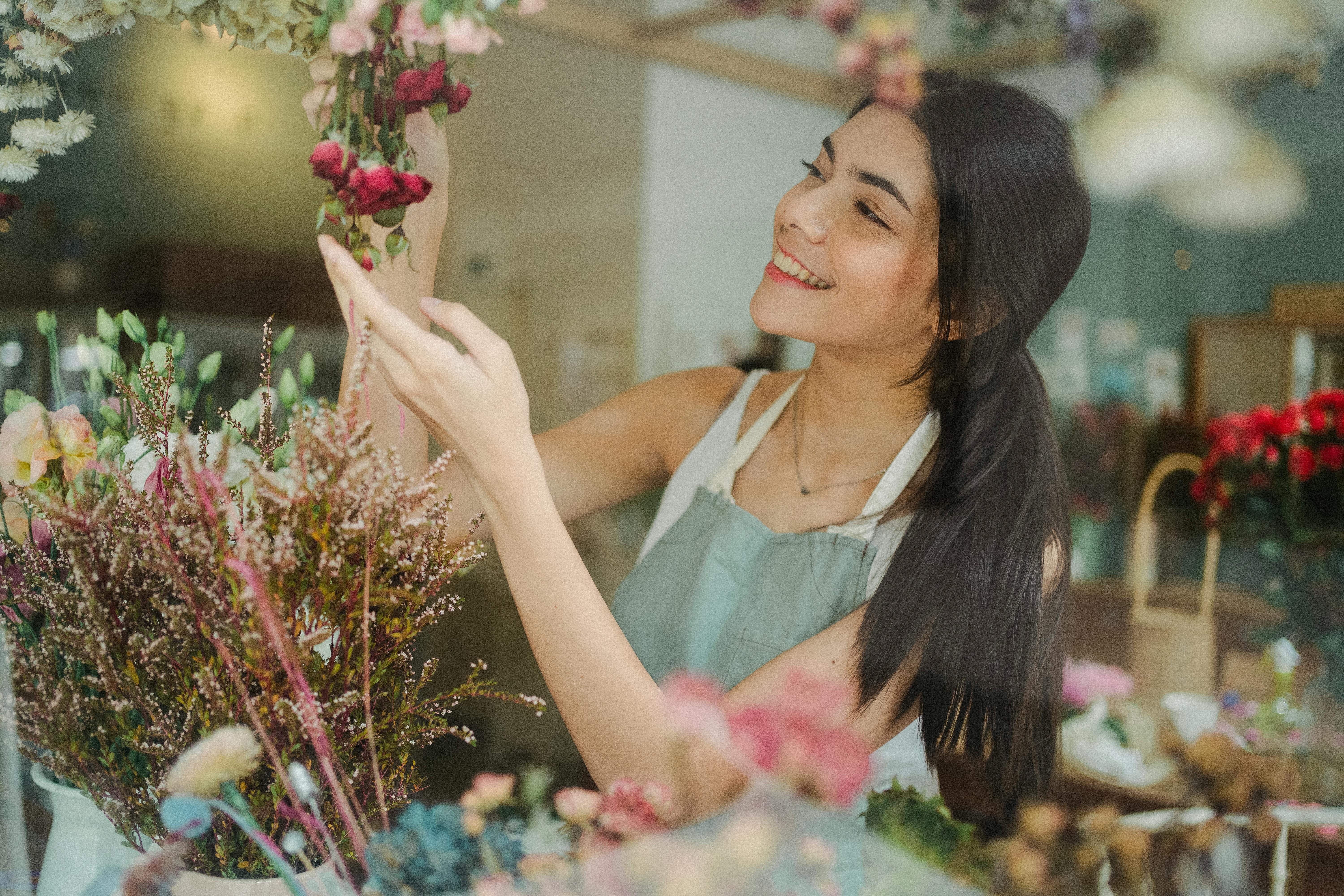 happy woman with flowers during work