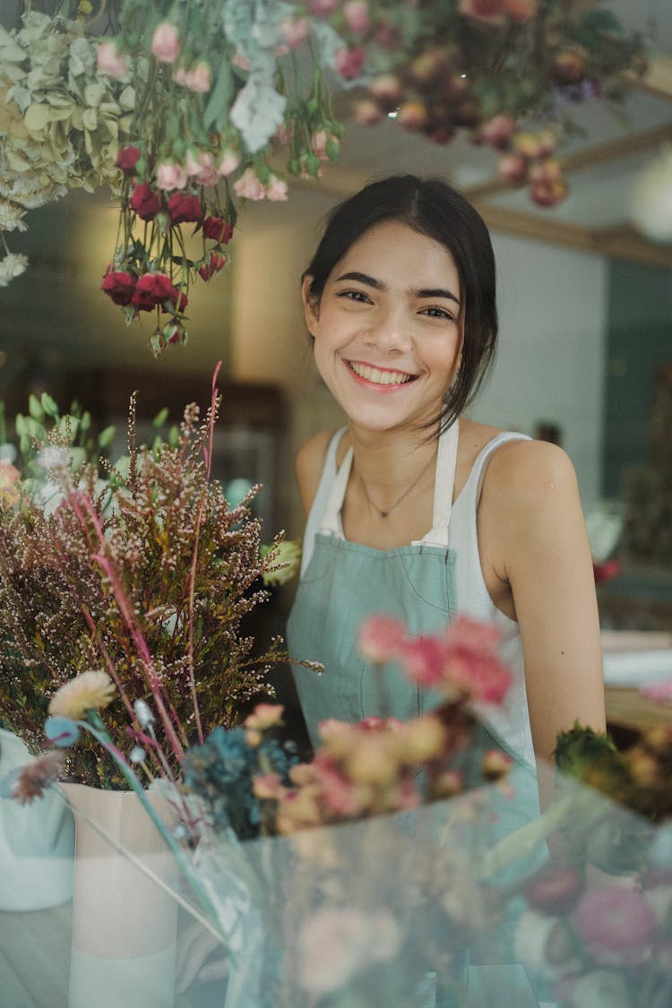 Cheerful Young Florist In Shop