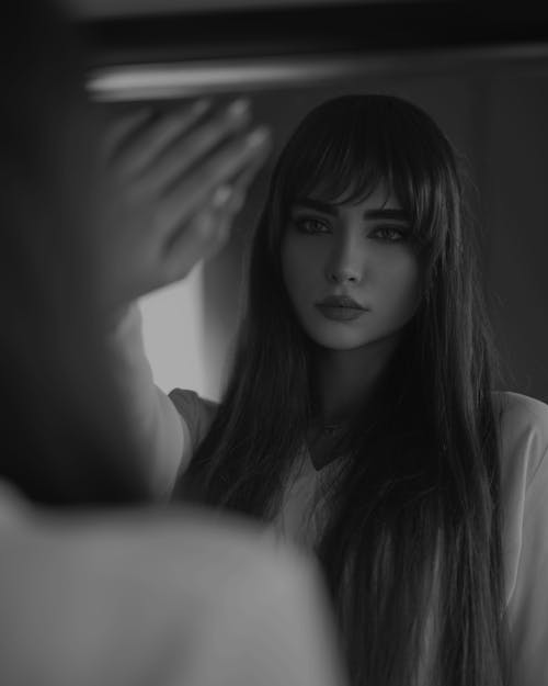 Grayscale Photo of a Woman in White Shirt