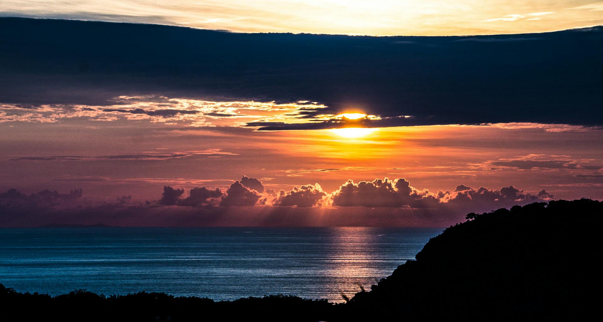 Beautiful sunset in Kailua, Hawaii, with vibrant clouds and ocean reflections.