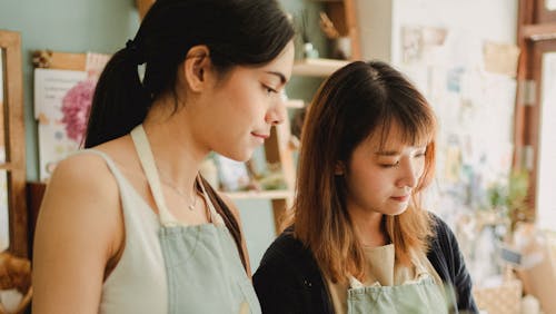 Focused multiracial women working in floral shop