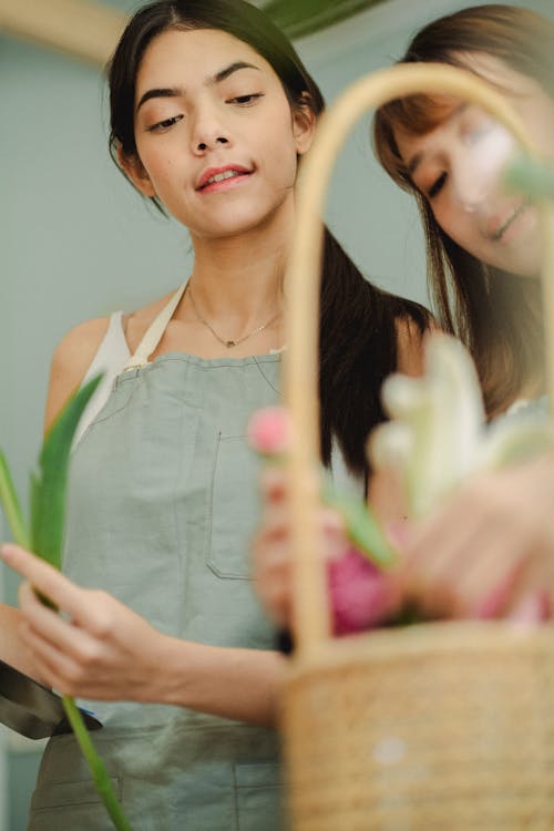 Content multiracial women arranging flowers