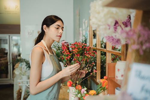 Thoughtful woman with bouquet of flowers