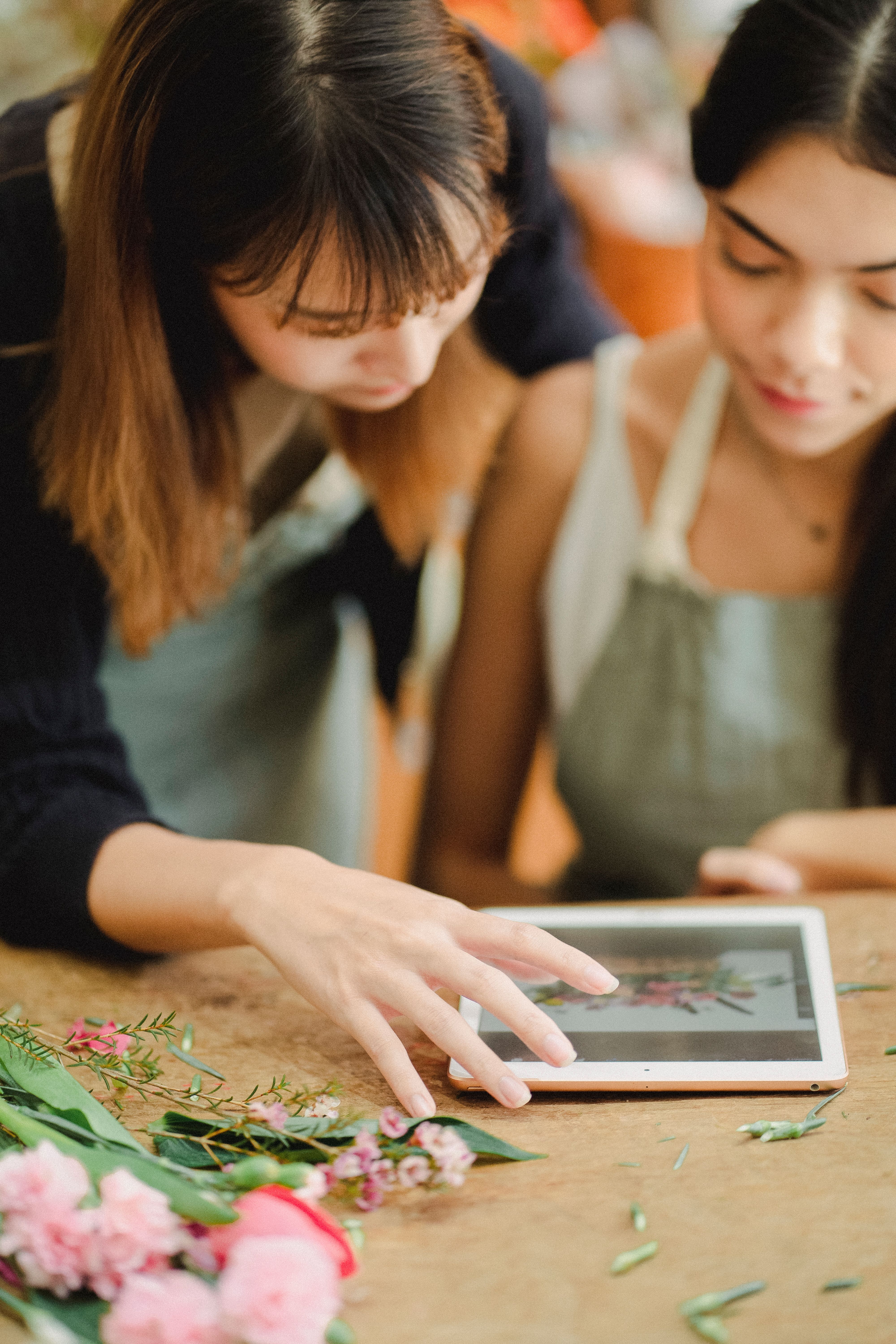 Free Young diverse women with tablet in workspace Stock Photo