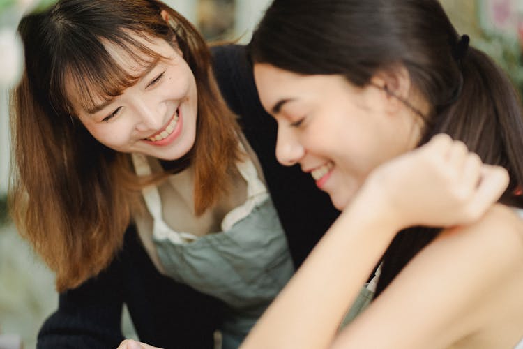 Happy Multiracial Women Working Together In Shop