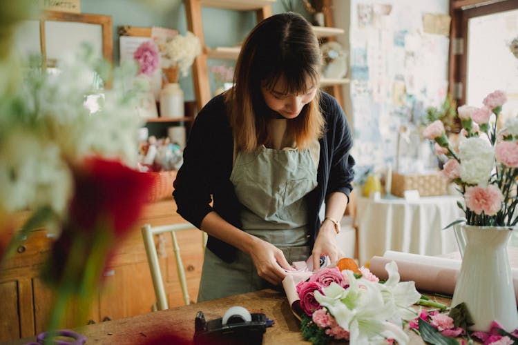 Woman Making Floral Bouquet In Shop