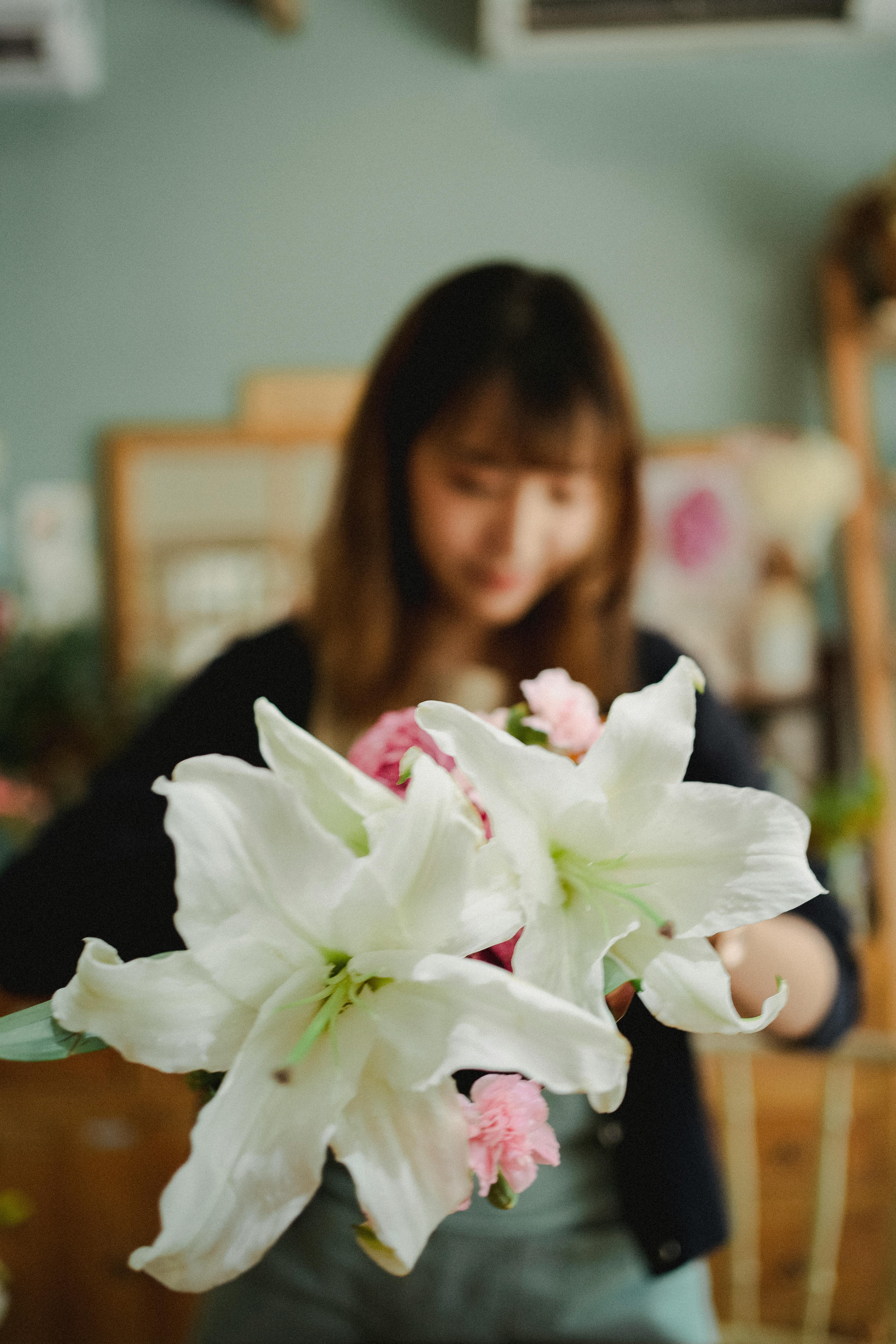 faceless woman holding bouquet of flowers