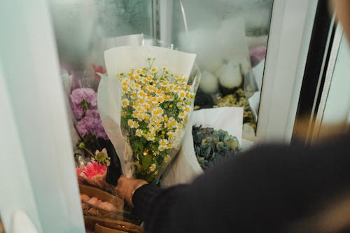 Урожай женщина с цветами в магазине