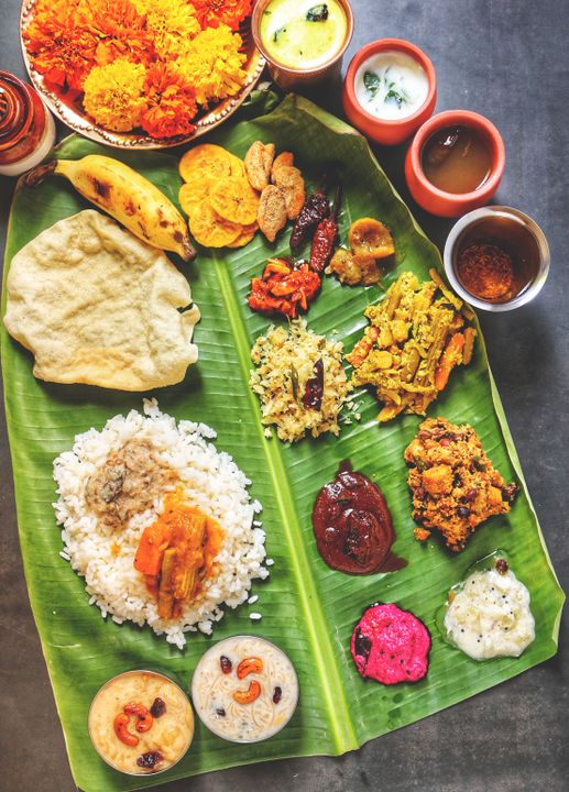 Indian Regional Cuisines You Can Learn to Cook in Ahmedabad 2 A Kerala sadya feast served on a banana leaf, representing the richness of South Indian regional cooking traditions.