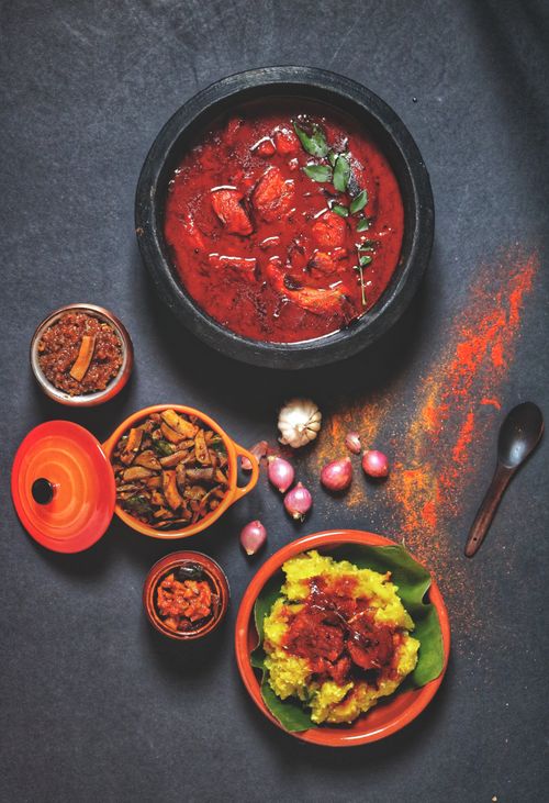 Free A delicious Indian meal with spicy curry, rice, and sides, garnished with herbs and spices. Stock Photo