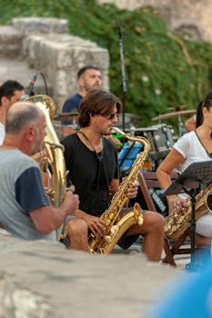Musicians playing saxophones in an outdoor setting, showcasing live music and entertainment.