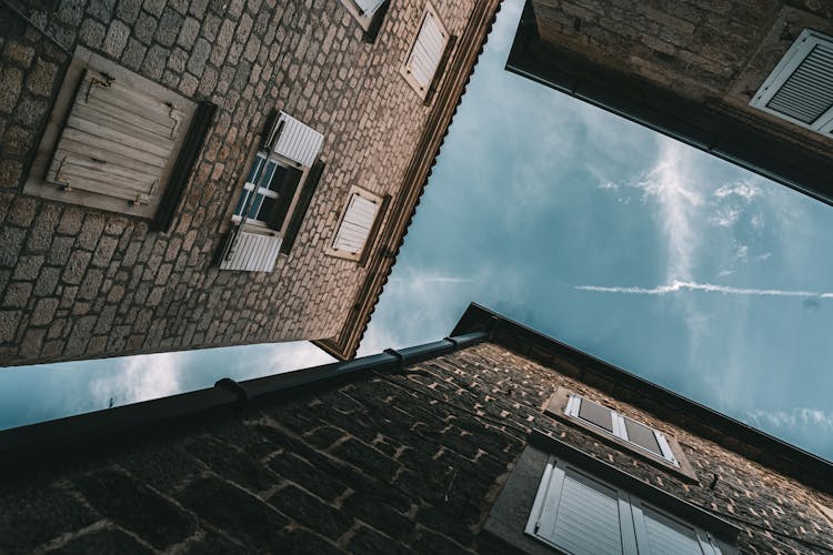 Brown Brick Walls Under Blue Sky With White Clouds