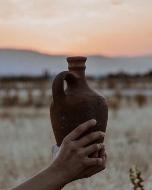 Free A Person Holding Clay Pot Jug Stock Photo