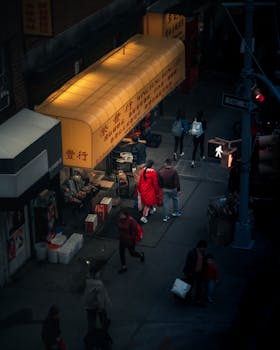 夜晚，霓虹灯下，人们走过充满活力的市场，构成一幅热闹的街景