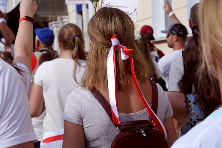 Woman In Gray Shirt With Red And White Ribbon On Hair