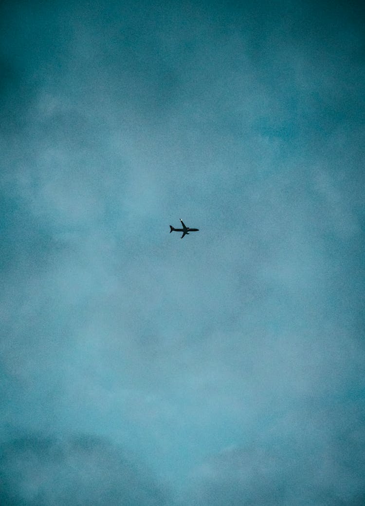 Airplane Flying Under Blue Sky