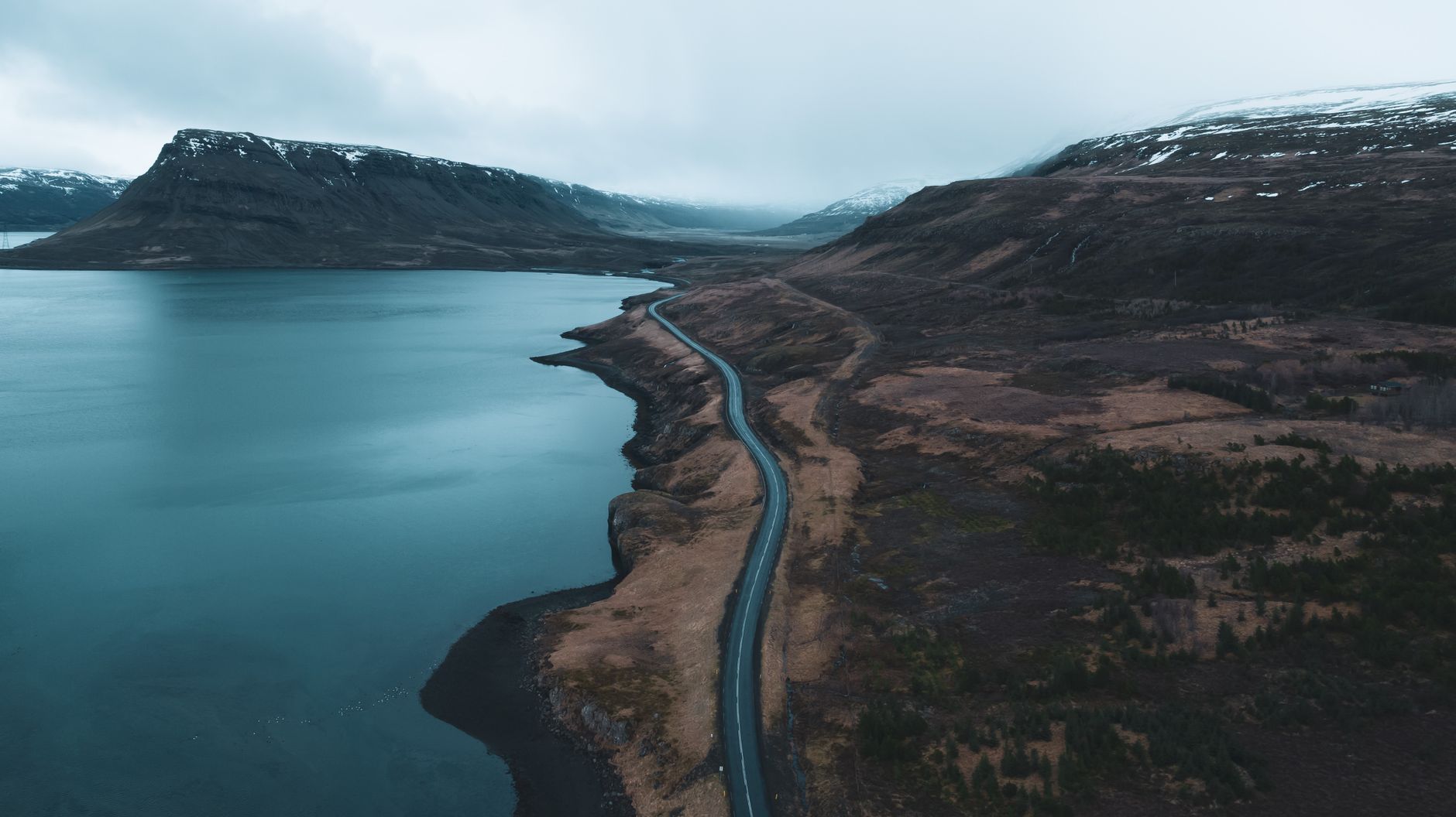 Empty road curving through East Iceland fjords
