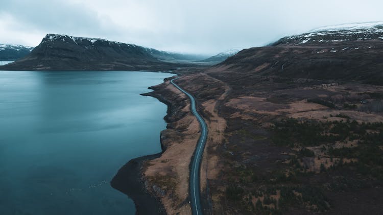 Road Near Mountains And Body Of Water 