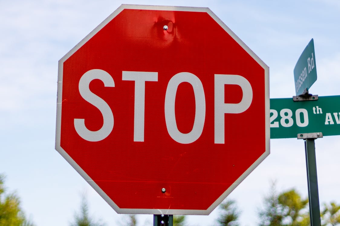 Free Stop Sign in Close-Up Photography Stock Photo