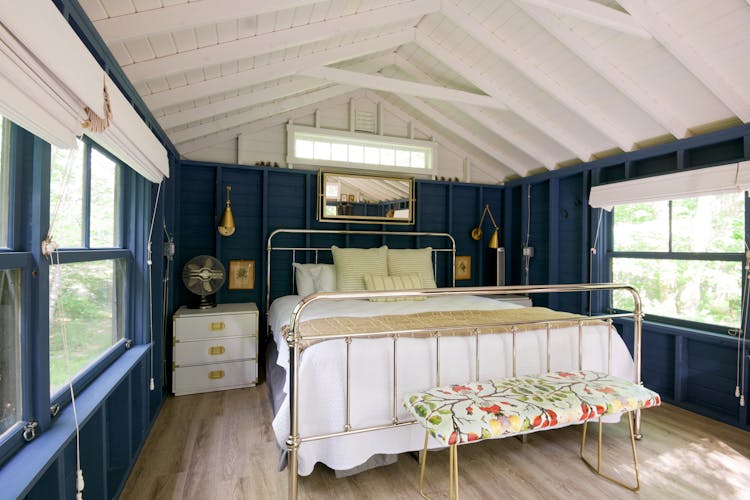 A Wrought Iron Bed In A Bedroom