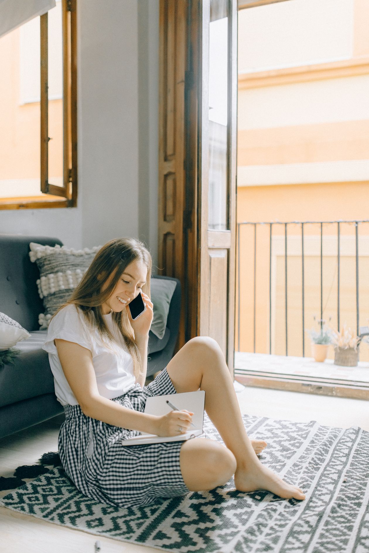 Woman relaxing on a black and white tribal patterned rug