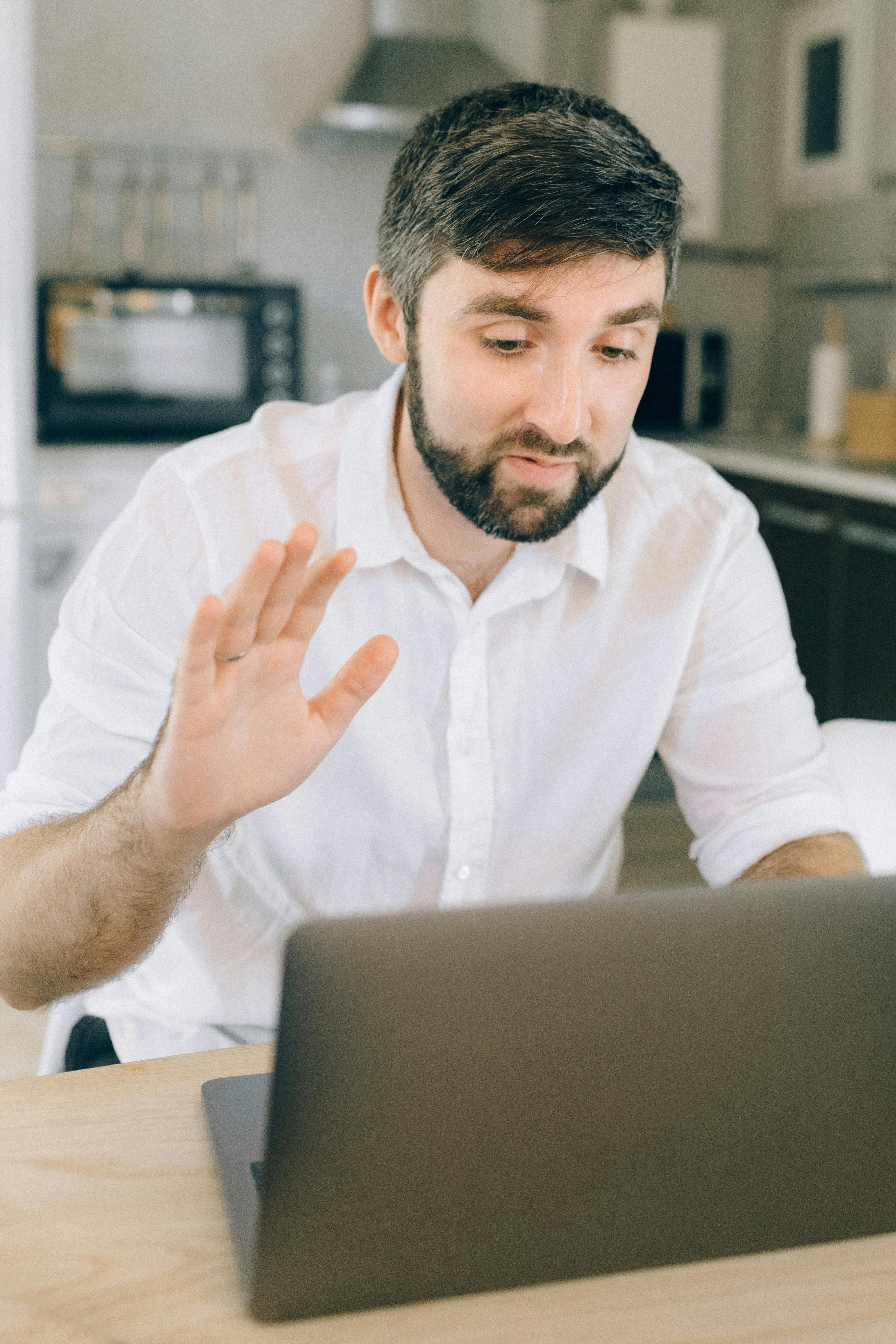 Man With Headphones Facing Computer Monitor · Free Stock Photo