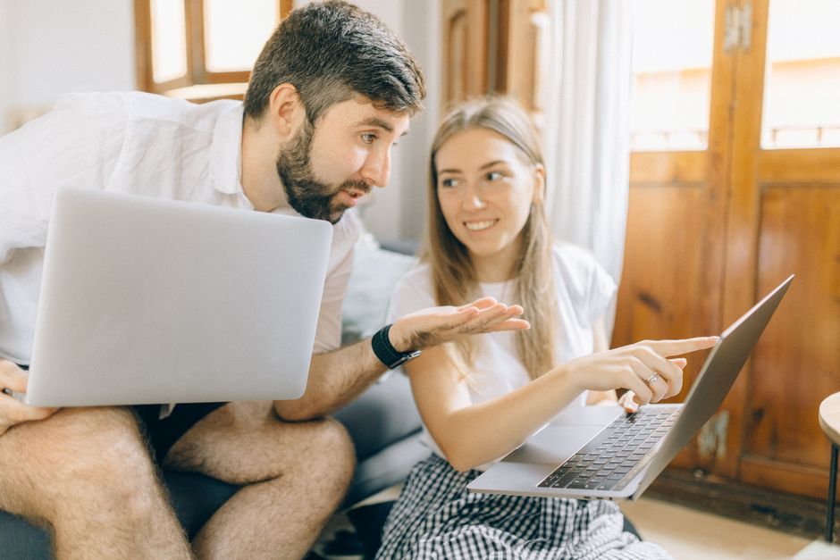 What Dermatologists Say About Baby Sunscreen Ingredients and SPF Young couple sitting together, discussing something on their laptops in a cozy room.