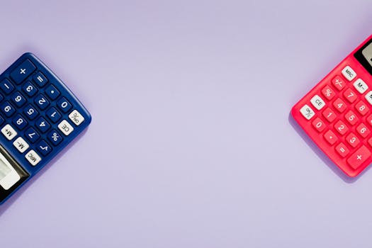 Two colorful calculators on a purple surface, offering ample copy space.