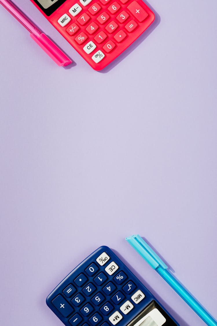 A Red And Blue Calculators With Matching Ball Pens