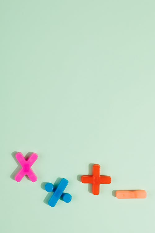 Free Math Symbols in Various Colors on Blue Surface Stock Photo