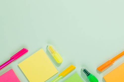 Free Vibrant office stationery including pens and sticky notes with ample copy space. Stock Photo