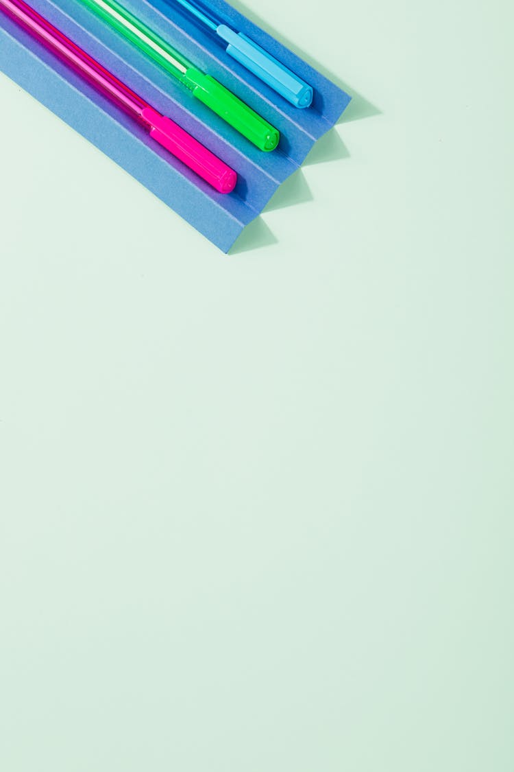 Ball Pens In Various Colors On A Folded Paper