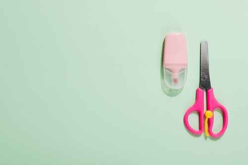 Free Flat lay image of pink scissors and pink marker on mint green surface with copy space. Stock Photo