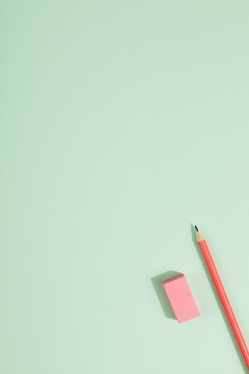 Free  Pencil and Mini Sticky Note on Pastel Green Surface Stock Photo